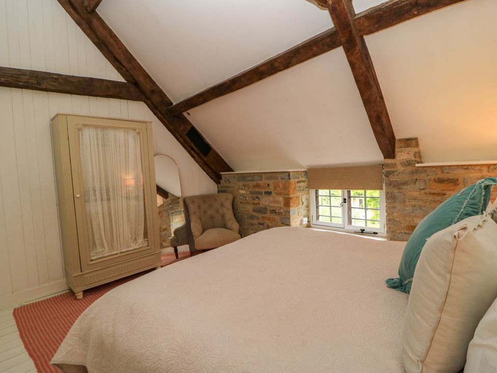 A bedroom with a bed and a window at The Farmhouse in Langport