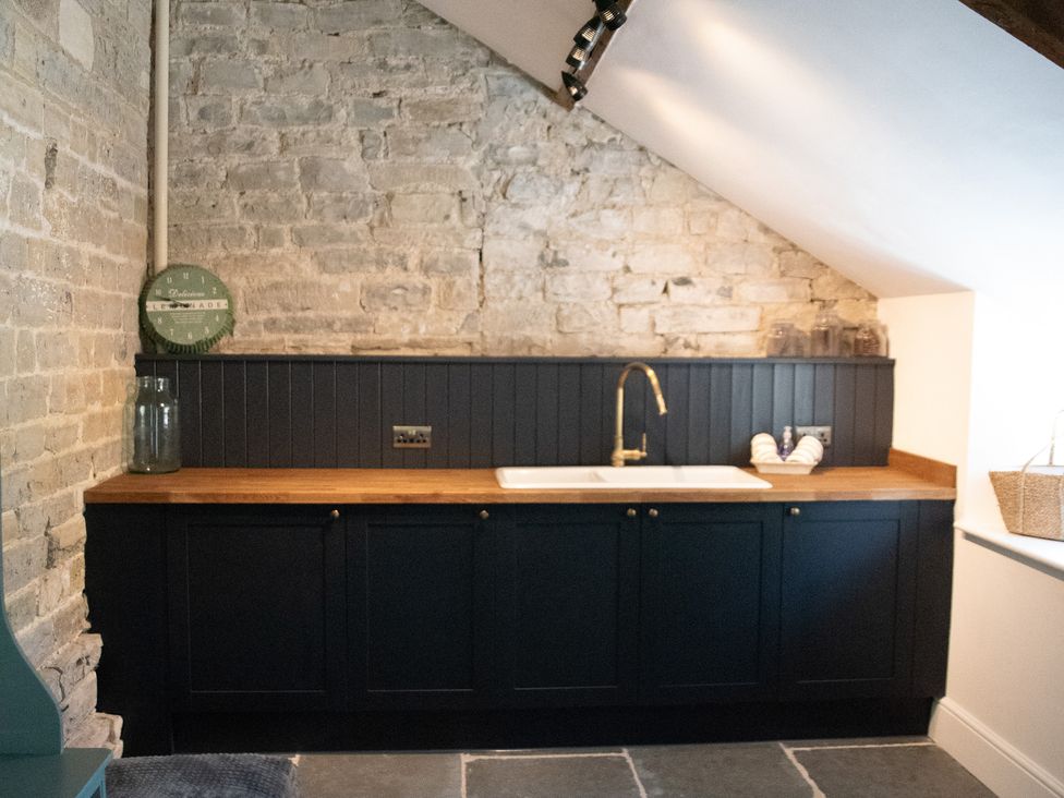A kitchen with a sink and countertop at The Farmhouse in Langport