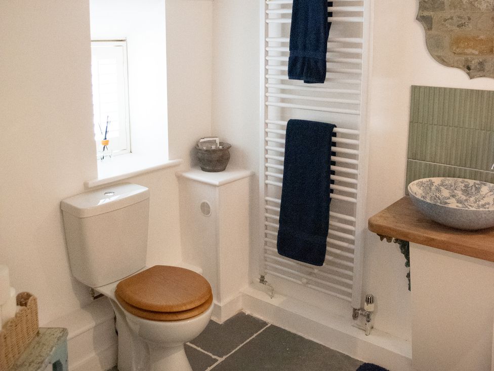 A bathroom with a toilet and a sink at The Farmhouse in Langport