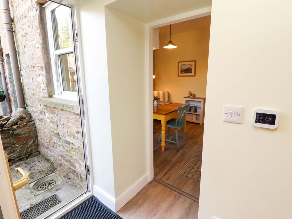 A view into a dining room with a table and chairs at East View in Kirkby Stephen