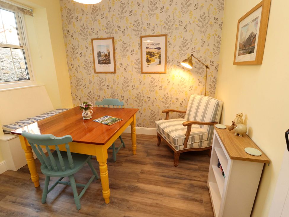 A dining room with a wooden table and chairs at East View in Kirkby Stephen