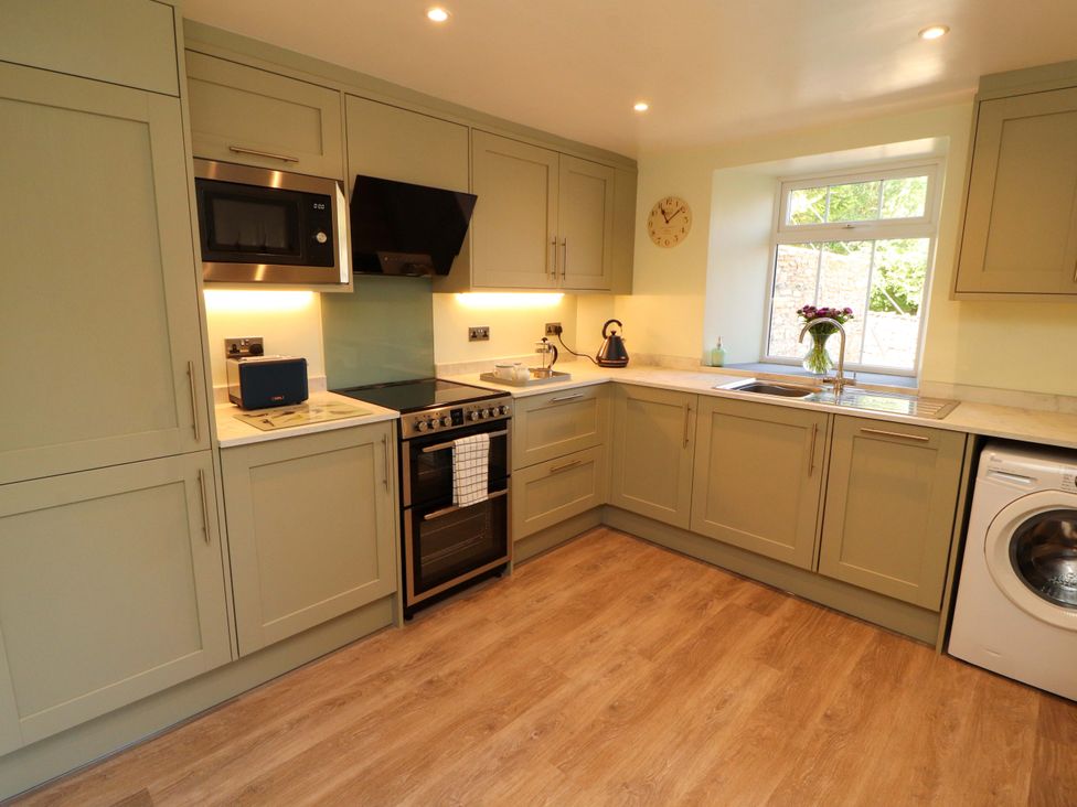 A kitchen with cabinets and appliances at East View in Kirkby Stephen