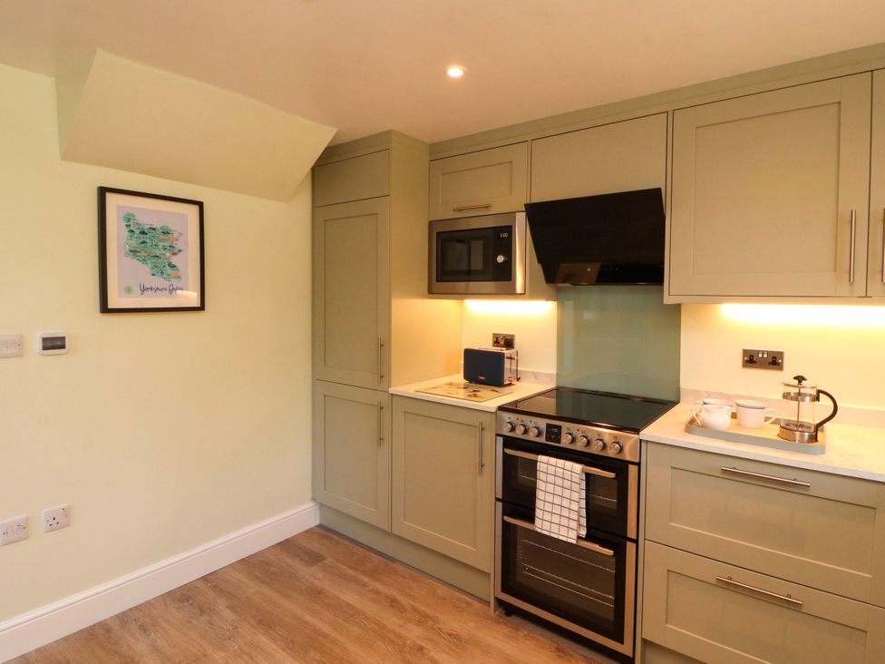A kitchen with cabinets and appliances at East View in Kirkby Stephen