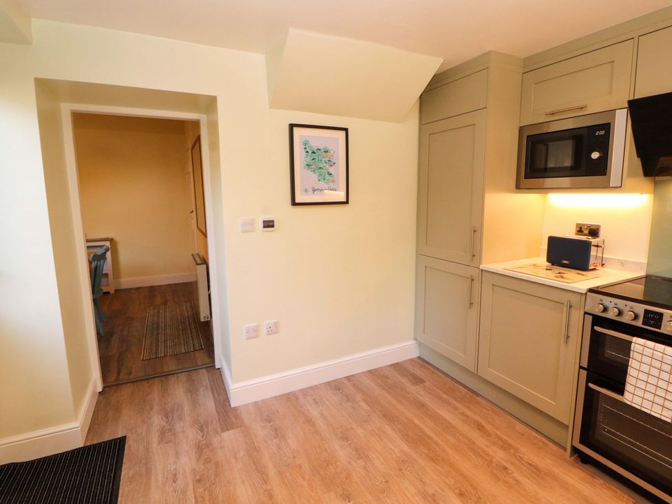 A kitchen with appliances and cabinets at East View in Kirkby Stephen