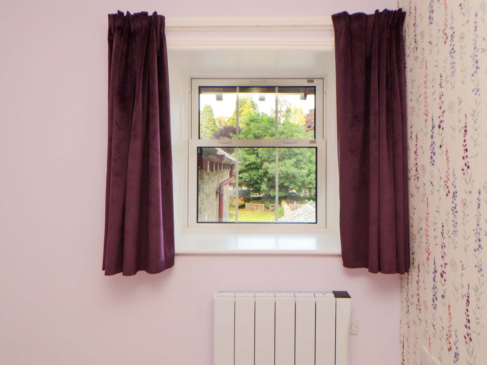 A bedroom with a window and radiator at East View in Kirkby Stephen