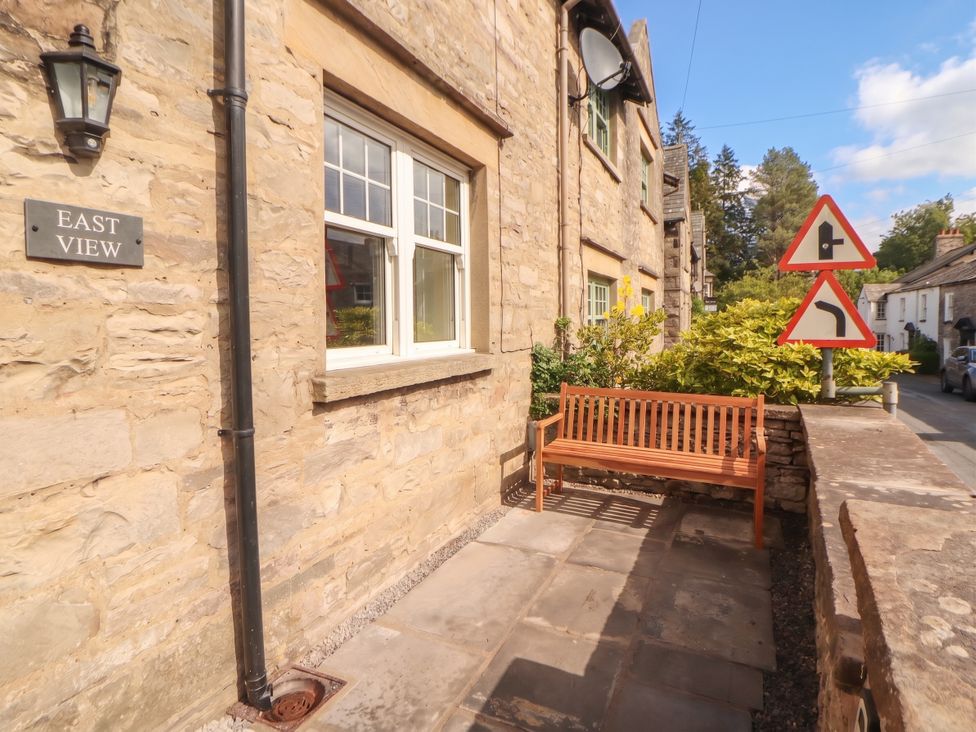 An outdoor area with a bench and signage at East View Ravenstonedale near Kirkby Stephen