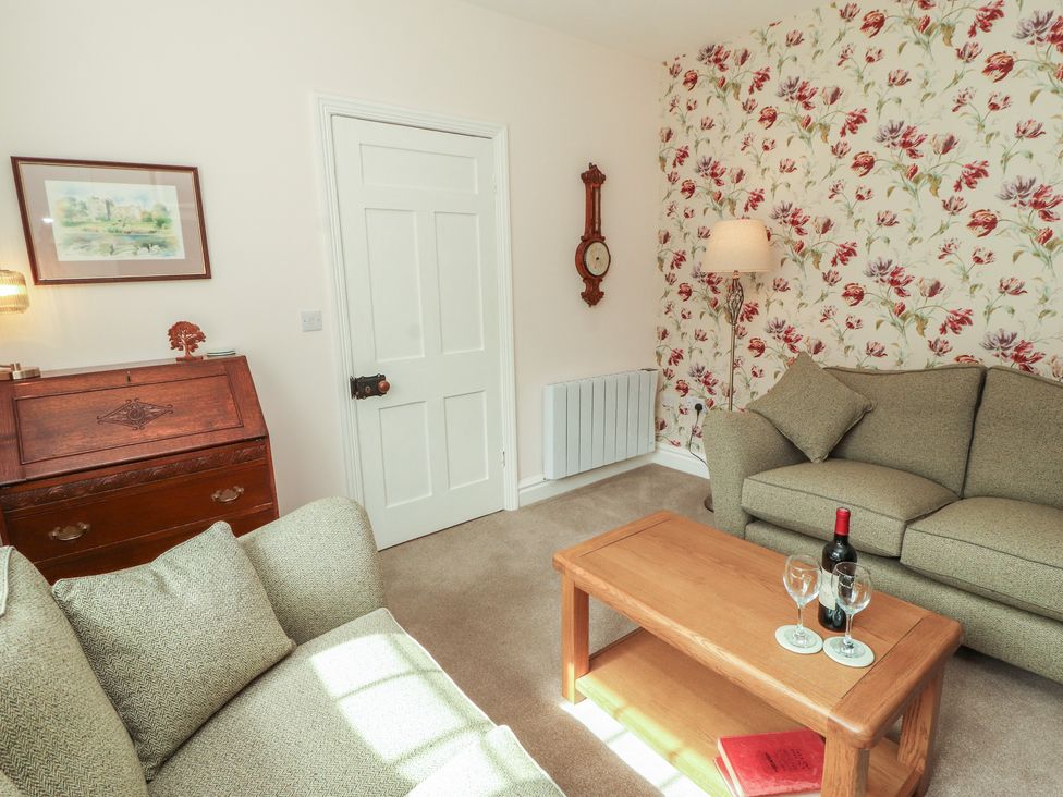 A living room with a coffee table and sofa at East View in Ravenstonedale near Kirkby Stephen