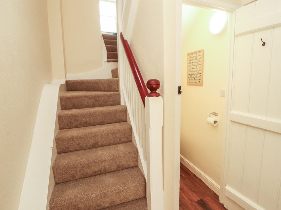 A hallway with stairs and a door at East View in Ravenstonedale near Kirkby Stephen