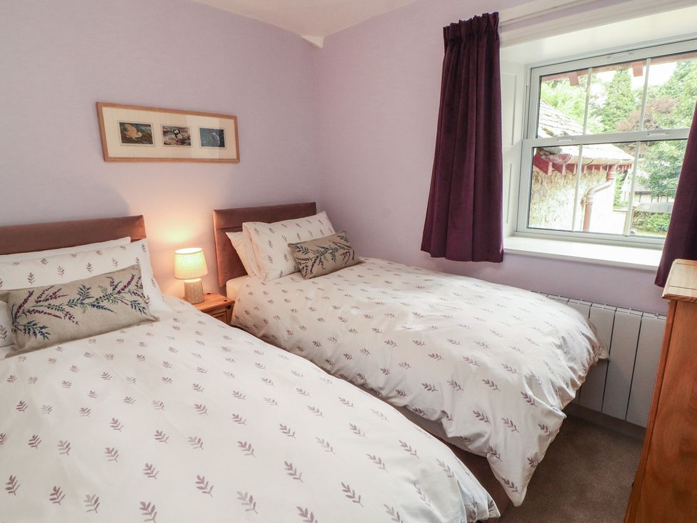A bedroom with twin beds and a window at East View in Ravenstonedale near Kirkby Stephen
