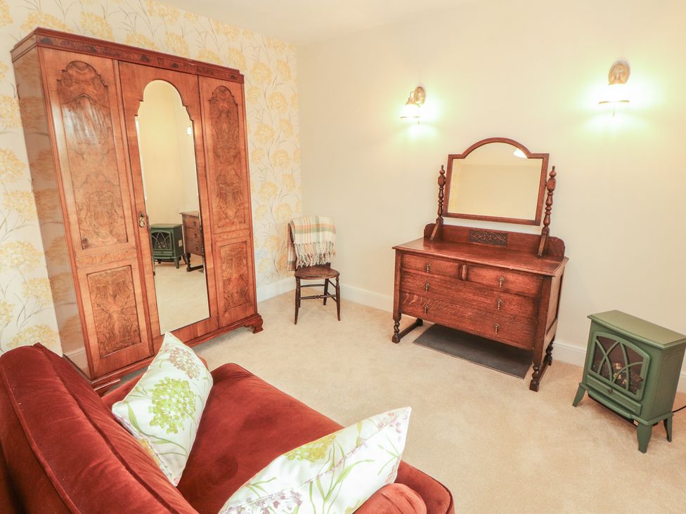 A bedroom with furniture including a wardrobe and dressing table at East View in Ravenstonedale near Kirkby Stephen