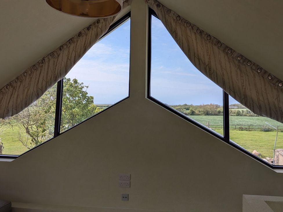 A room with large windows and curtains at The Rookery in Rosslare Harbour, County Wexford