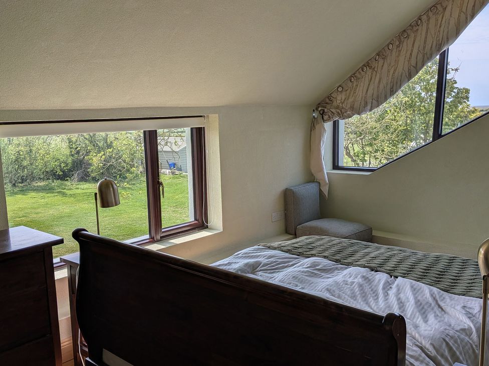 A bedroom with a window and bed at The Rookery in Rosslare Harbour, County Wexford