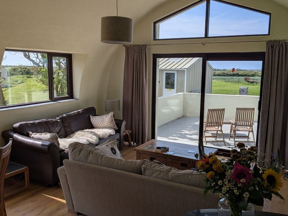 A living room with a sofa and coffee table at The Rookery in Rosslare Harbour, County Wexford