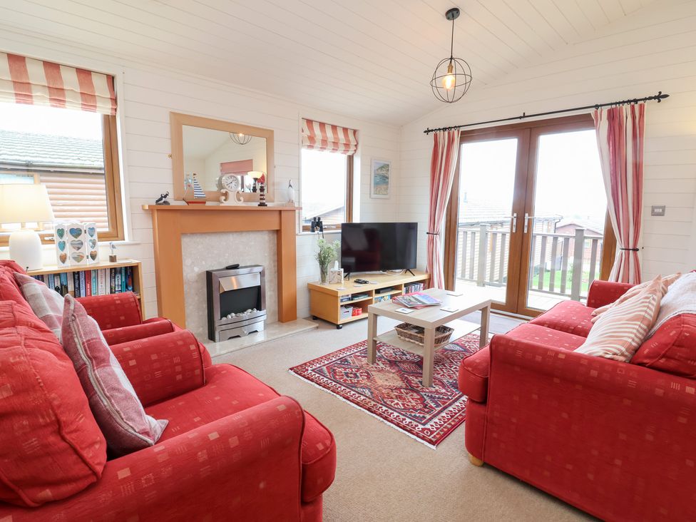 A living room with a television and sofa at Ocean Terrace 28 Ilfracombe