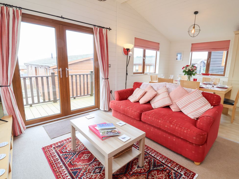 A living room with a sofa and coffee table at Ocean Terrace 28 in Ilfracombe