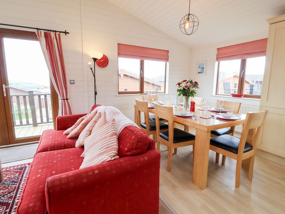 A dining room with a table and chairs at Ocean Terrace 28 Ilfracombe