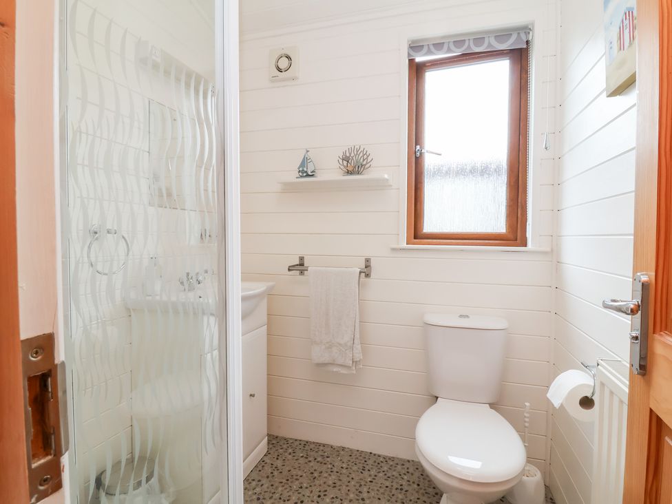A bathroom with a shower, sink, and toilet at Ocean Terrace 28 Ilfracombe