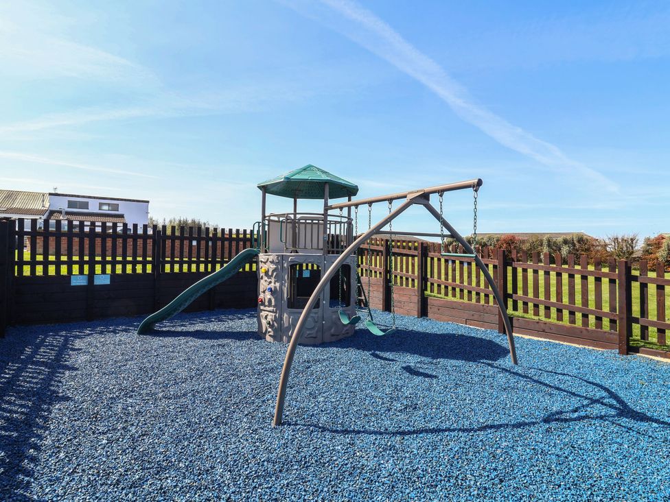 A playground with a slide and swing at Ocean Terrace 28 Mullacott Ilfracombe