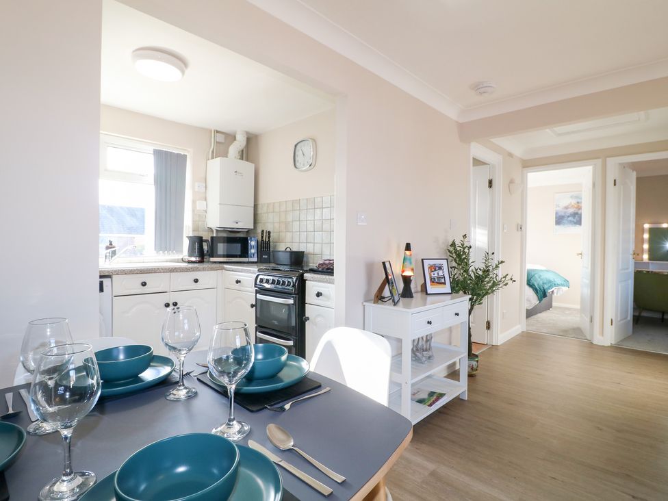 A kitchen with a dining table set for meals and appliances at The Cuckoo's Rest in Melton Mowbray