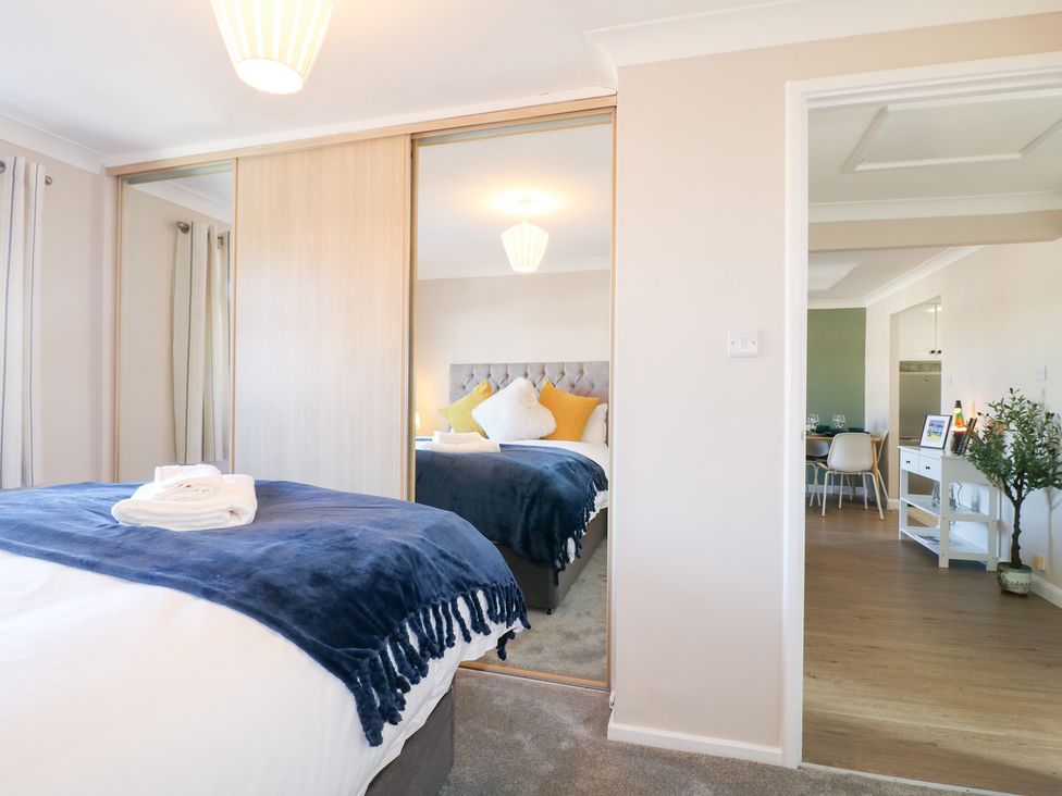 A bedroom with a bed and wardrobe at The Cuckoo's Rest in Melton Mowbray