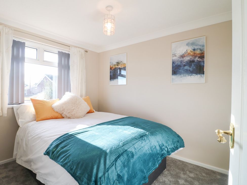 A bedroom with a bed and artwork on the walls at The Cuckoo's Rest in Melton Mowbray