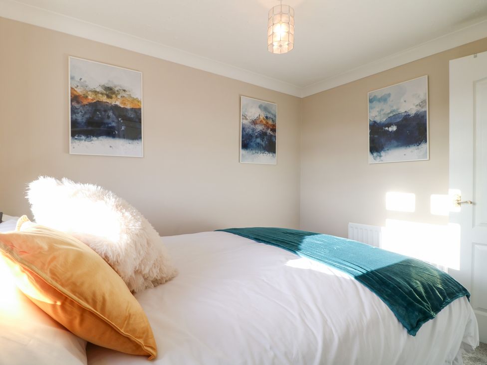 A bedroom with a bed and wall art at The Cuckoo's Rest in Melton Mowbray