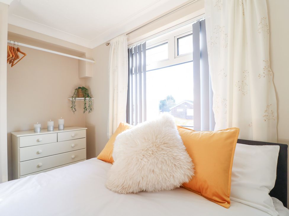 A bedroom with a bed and dresser at The Cuckoo's Rest in Melton Mowbray