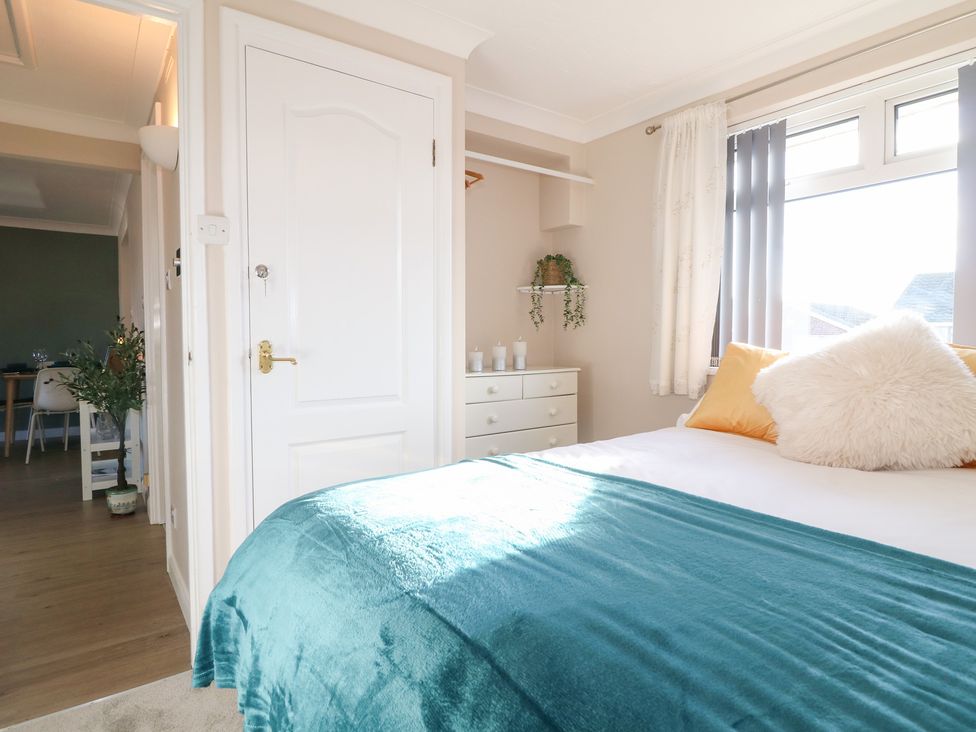 A bedroom with a bed and dresser at The Cuckoo's Rest in Melton Mowbray