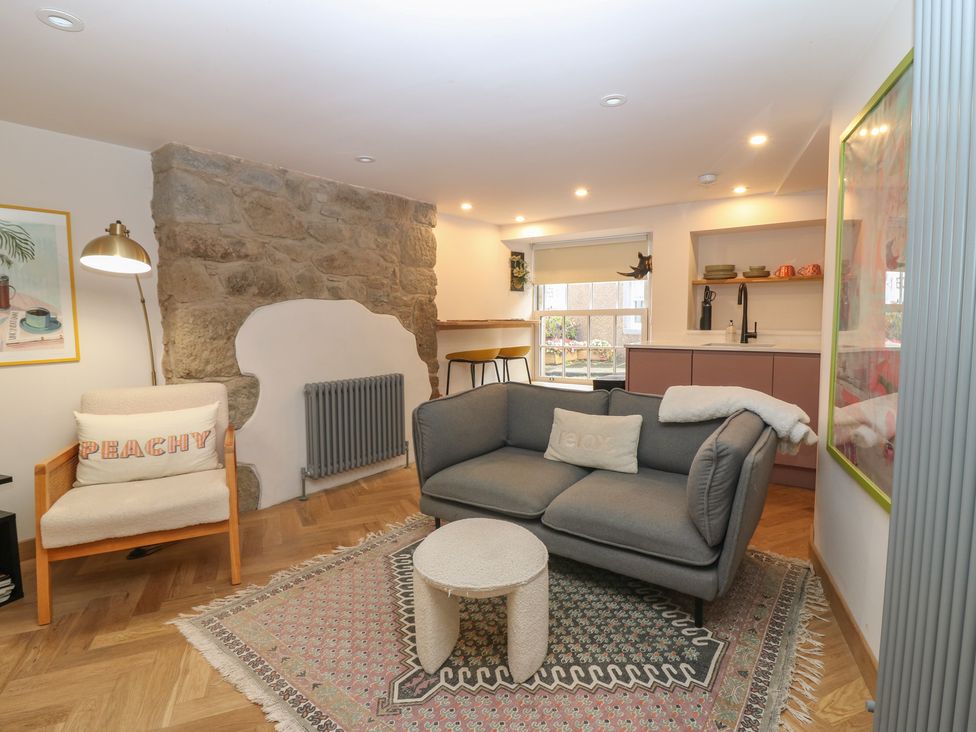 A living room with a sofa and armchair at 2 East Port in Melrose
