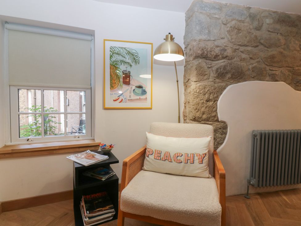 A living room with a chair and a window at 2 East Port in Melrose