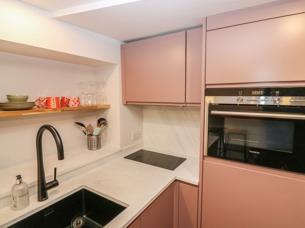 A kitchen with cabinets and sink at 2 East Port in Melrose