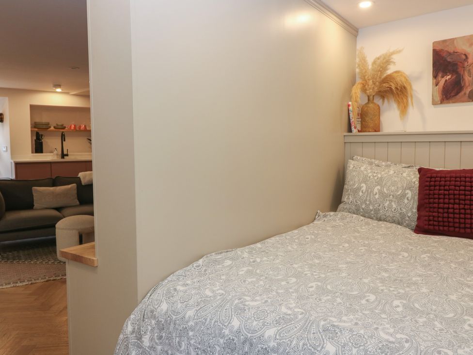 A bedroom with a bed and wall art at 2 East Port in Melrose
