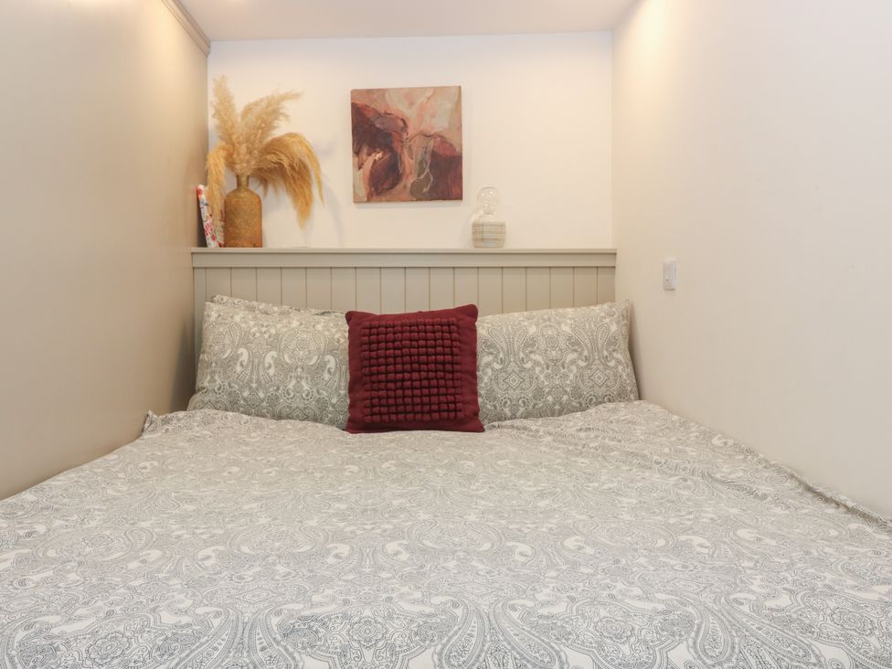 A bedroom with a bed and decorative items at 2 East Port in Melrose