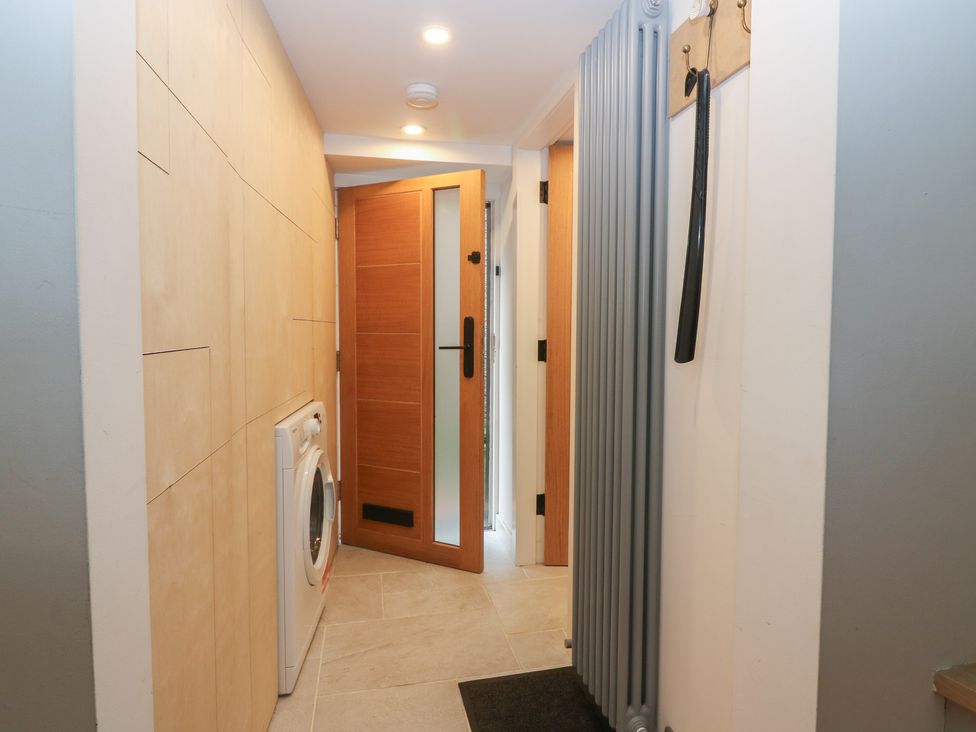 A laundry room with a washer and a door at 2 East Port in Melrose