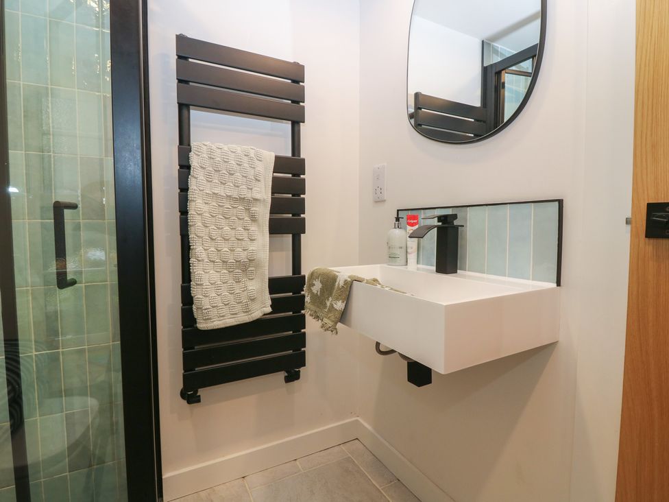 A bathroom with a sink and mirror at 2 East Port Melrose