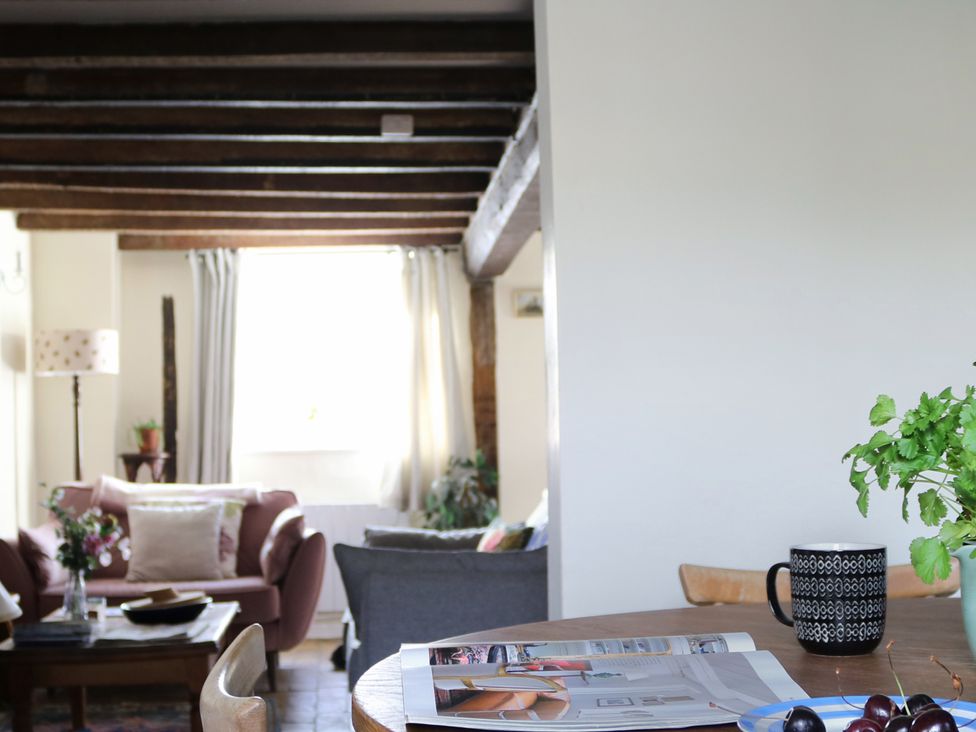A living room with a table and mug at The Old Post Box in 