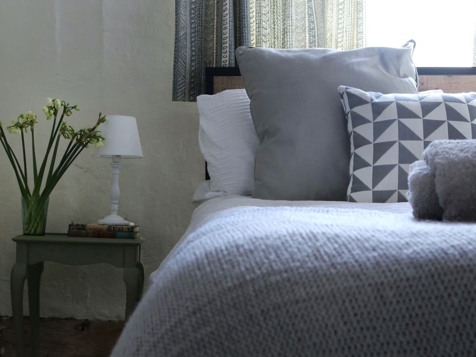 A bedroom with a bed and pillows at The Old Post Box in 