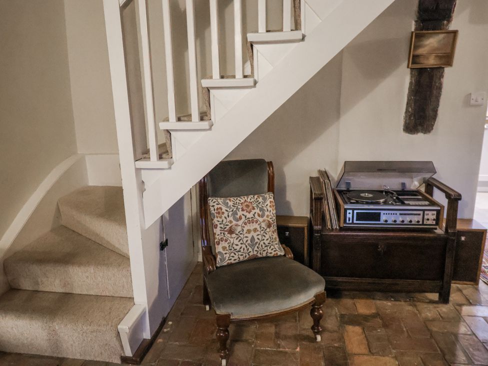 A living room with a chair and record player at The Old Post Box in Halesworth