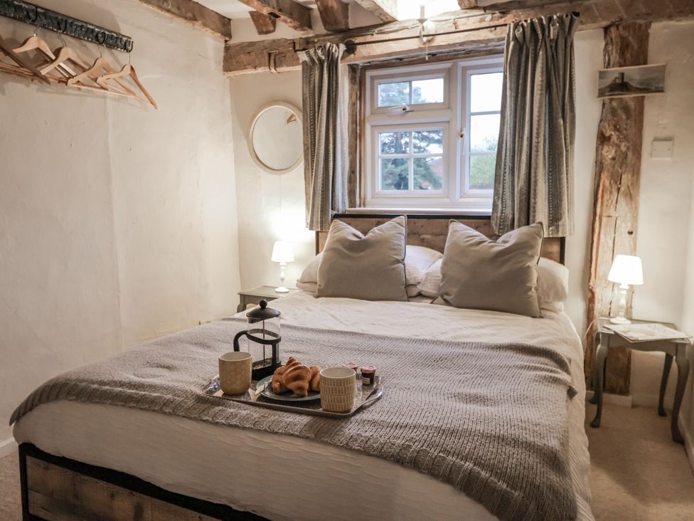 A bedroom with a bed and breakfast tray at The Old Post Box in Halesworth