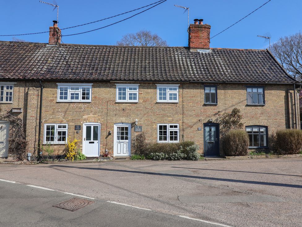 A row of houses with windows and doors at The Old Post Box in Halesworth