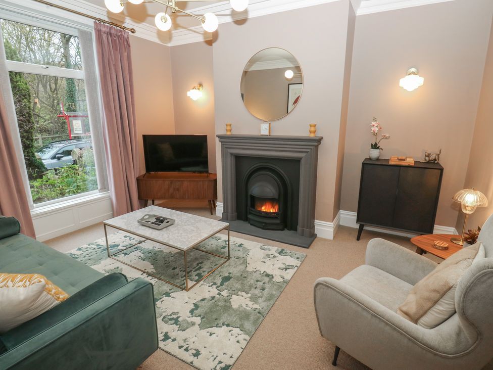 A living room with a sofa and coffee table at Fairfield House in Almondbury
