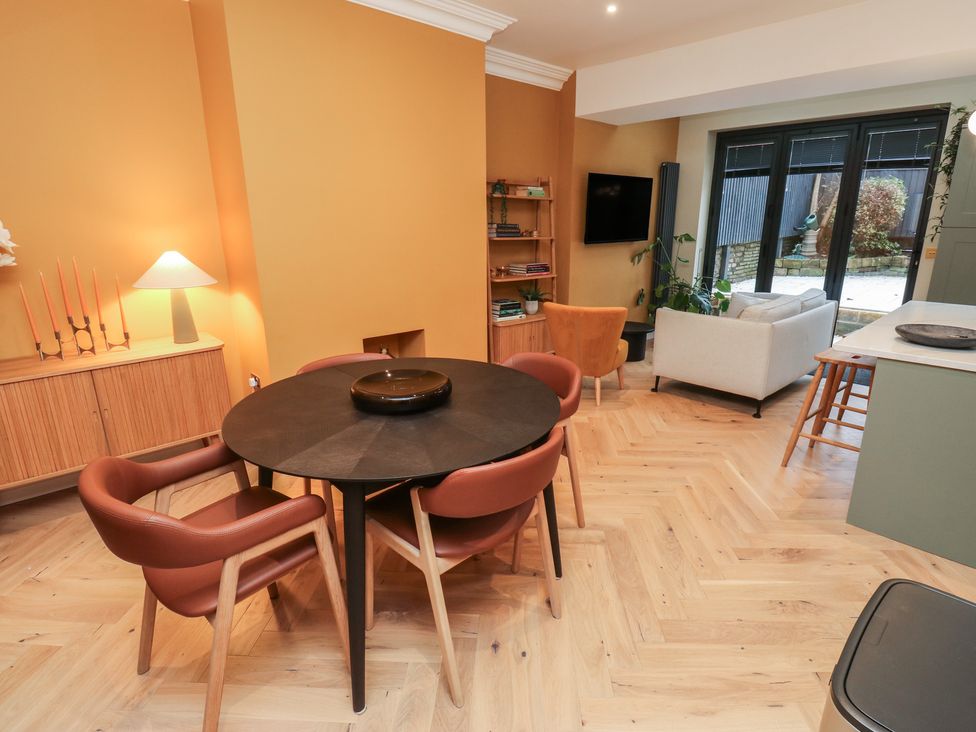 A dining room with a table and chairs at Fairfield House in Almondbury