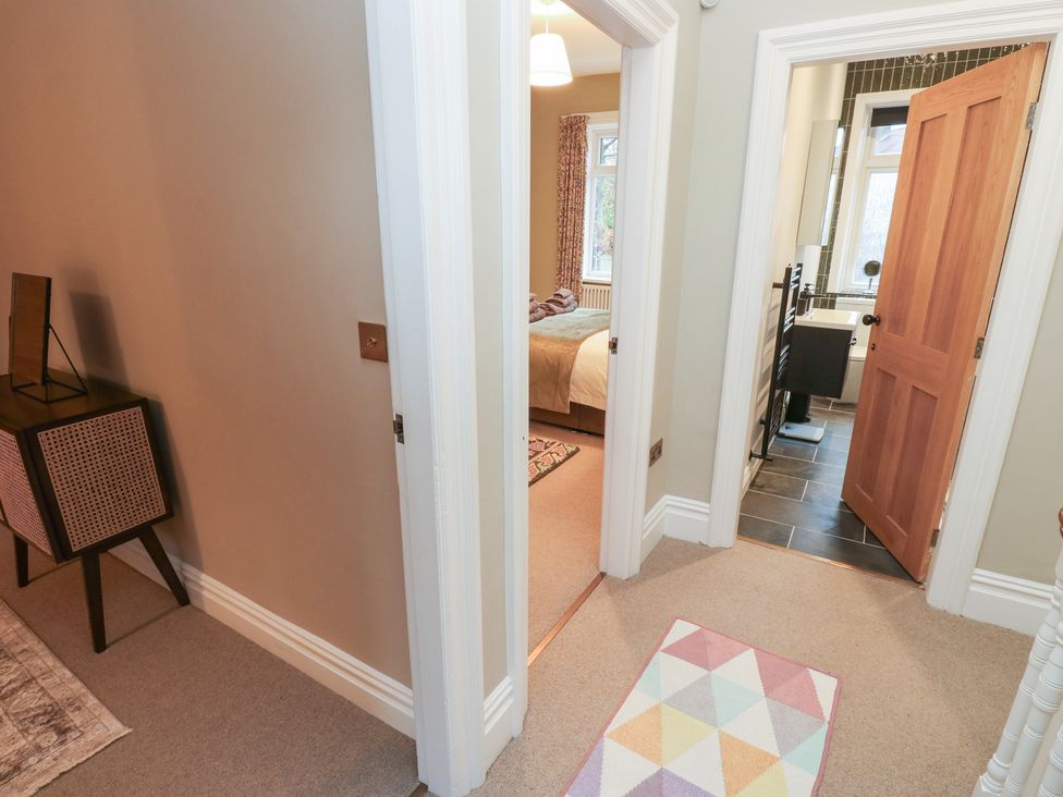 A hallway with doors leading to a bedroom and bathroom at Fairfield House Almondbury