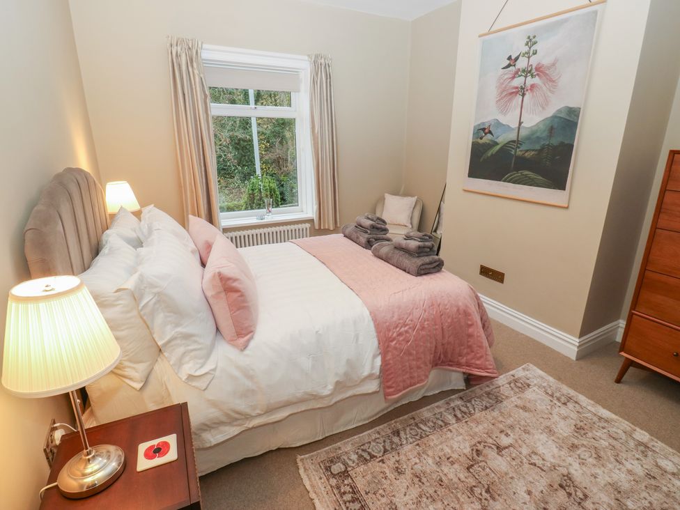 A bedroom with a bed and a dresser at Fairfield House in Almondbury