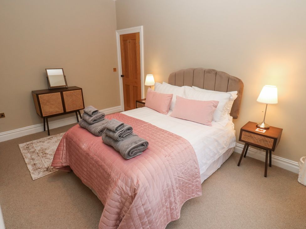 A bedroom with a bed and lamp at Fairfield House Almondbury