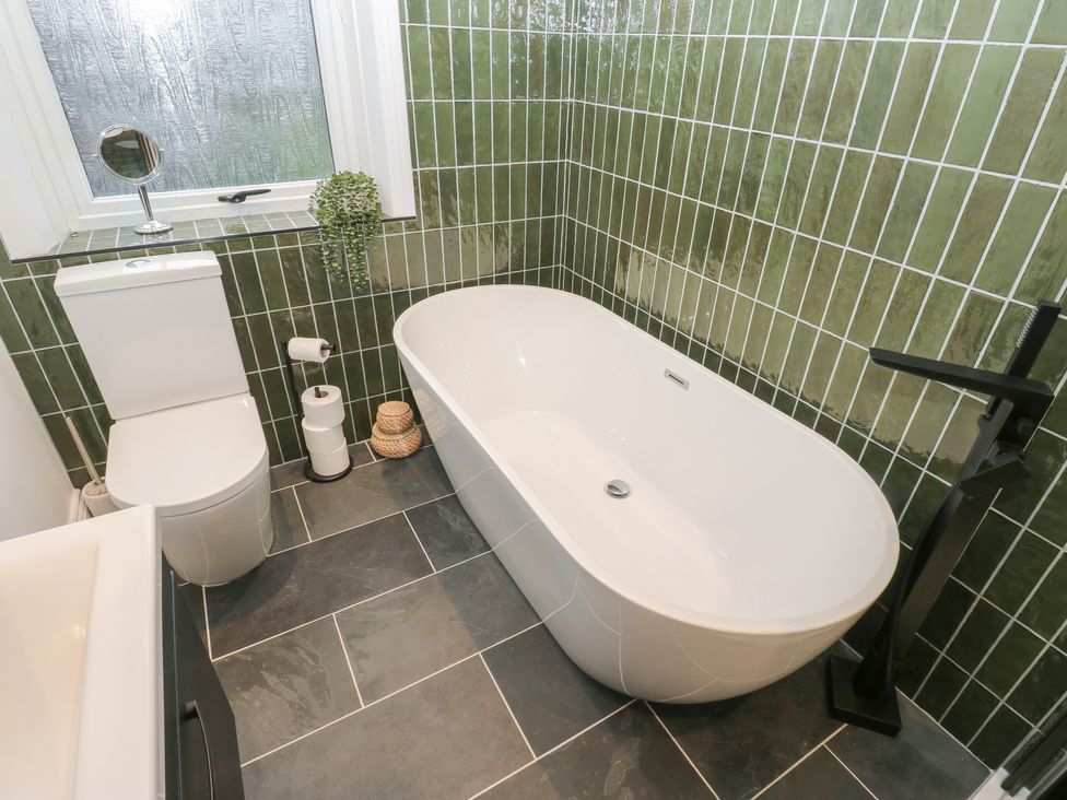 A bathroom featuring a bathtub and toilet at Fairfield House in Almondbury