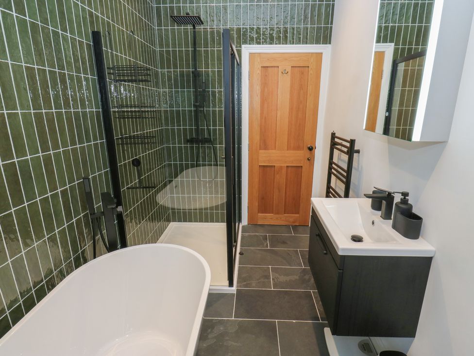 A bathroom with a bath tub and shower at Fairfield House in Almondbury