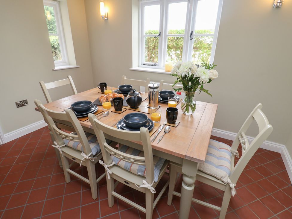 A dining room with a table set for breakfast at 6 Gravel Hill in King's Lynn