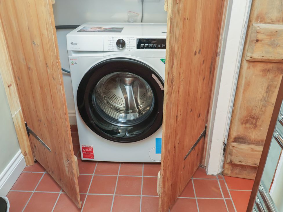 A washing machine in a laundry room at 6 Gravel Hill, King's Lynn