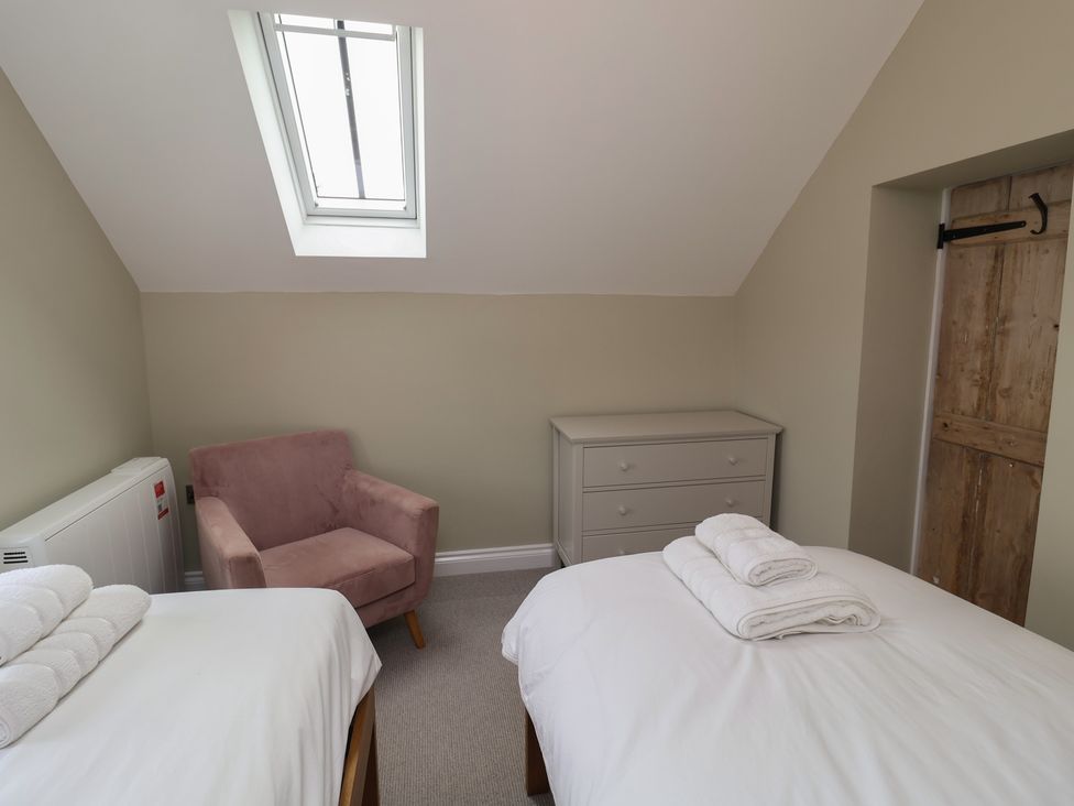 A bedroom with two beds and a dresser at 6 Gravel Hill in King's Lynn